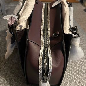 Authentic-NWT in box never unwrapped Coach purse. Unable to return.